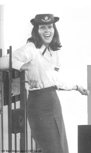 Woman wearing dark skirt, light blouse and hat with ‘VR Station Assistant’ across the front. 